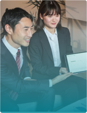 Two professionals collaborating at laptop